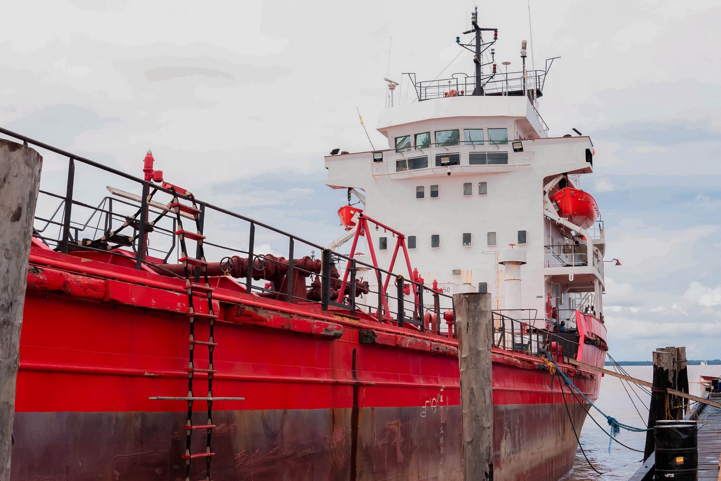 A GCITI tanker alongside the wharf in Guyana, cargo manifold and pipework on deck.